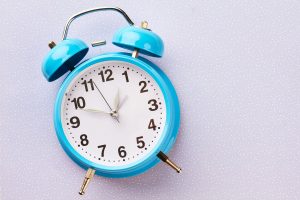 Blue retro alarm clock on white background